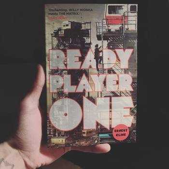 Holding out the book 'Ready Player One' by Ernest Cline