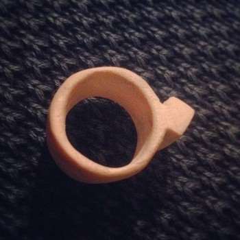 A carved wooden diamond ring