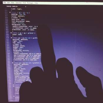 Background: computer display showing some css code. Forefround: Me giving the display the finger