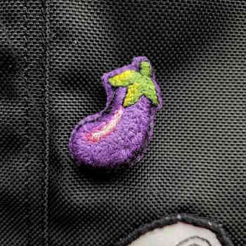 A purple embroidery eggplant pin